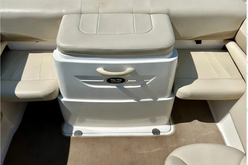 Slide: The Image of 2003 Chaparral 183 SS boat interior with beige seating and storage compartment. - 30