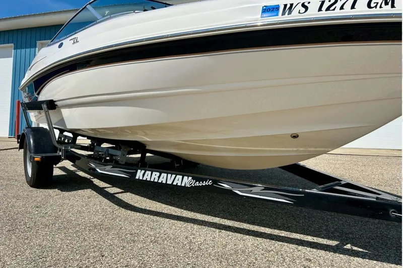 Slide: The Image of 2003 Chaparral 183 SS boat on Karavan Classic trailer, parked outdoors. - 4