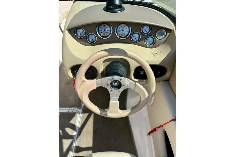 Slide: The Image of 2003 Chaparral 183 SS boat dashboard with steering wheel and gauges. - 9