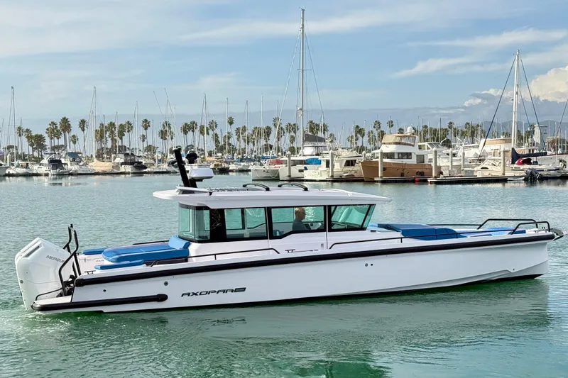 The Image of 2025 Axopar 37 XC Cross Cabin boat in marina, calm water, clear sky. - 0