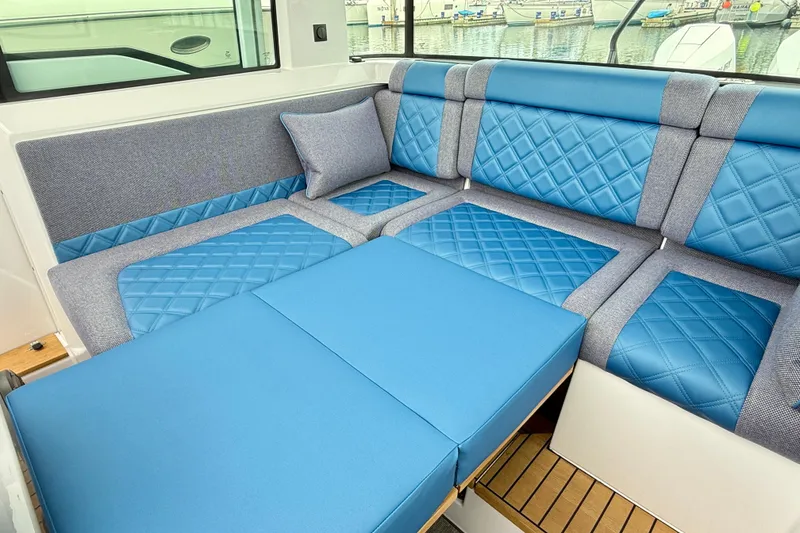 Slide: The Image of Luxurious blue seating in 2025 Axopar 37 XC Cross Cabin boat interior. - 16