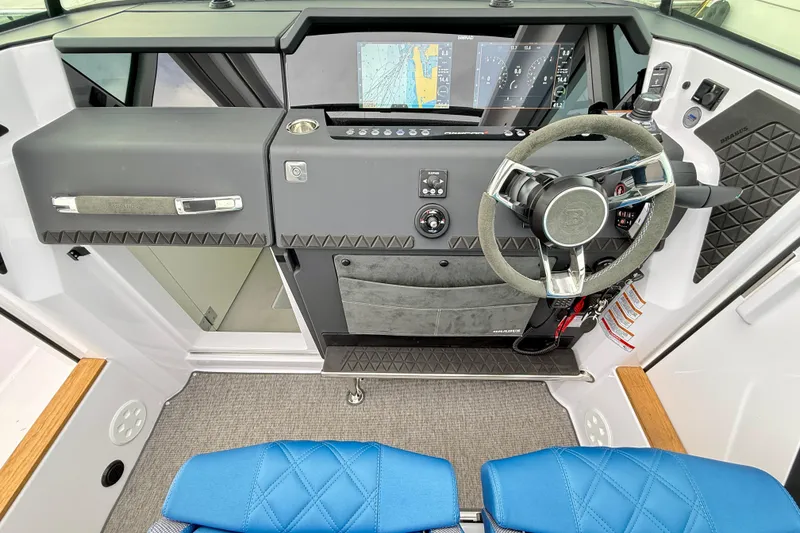 Slide: The Image of Interior of 2025 Axopar 37 XC Cross Cabin with blue quilted seating. - 17