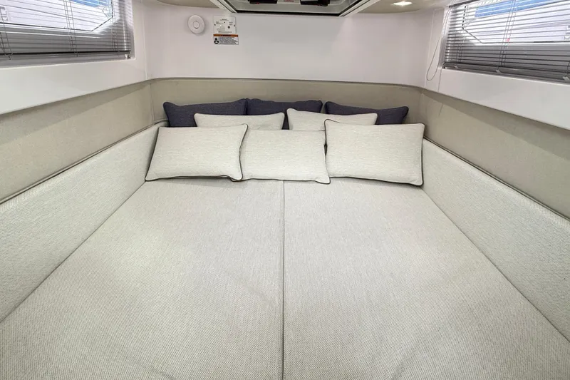 Slide: The Image of 2025 Axopar 37 XC Cross Cabin interior with open Dometic fridge, showcasing storage and seating. - 21