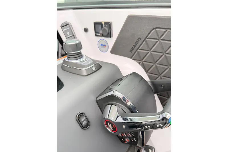 Slide: The Image of Control panel of 2025 Axopar 37 XC Cross Cabin with Simrad device and ignition keys. - 28