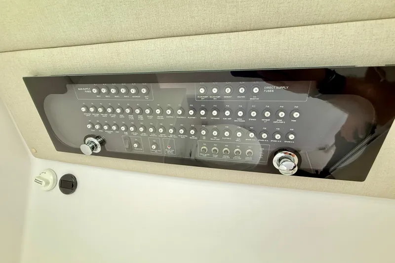 Slide: The Image of Control panel of 2025 Axopar 37 XC Cross Cabin with various switches and knobs. - 39