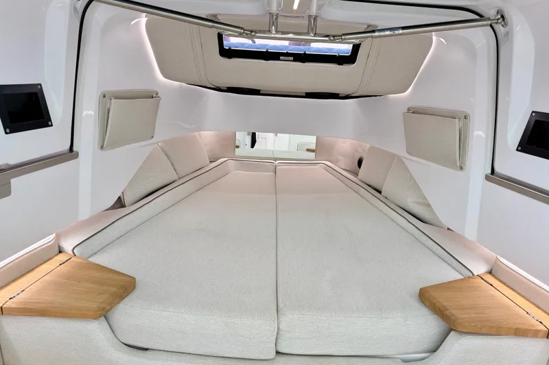 Slide: The Image of 2025 Axopar 37 XC Cross Cabin interior with spacious bed and modern design. - 40
