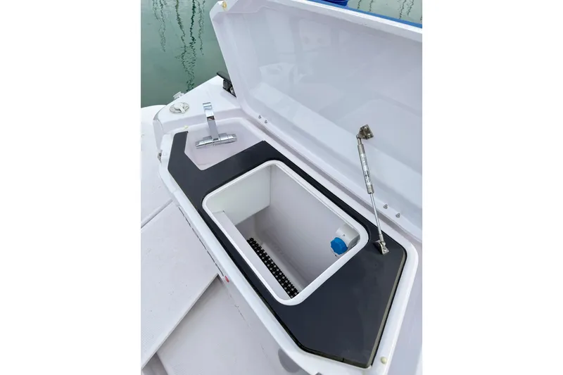 Slide: The Image of Open storage compartment on 2025 Axopar 37 XC Cross Cabin boat. - 51