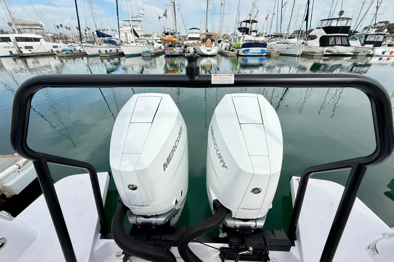 Slide: The Image of 2025 Axopar 37 XC Cross Cabin with twin Mercury outboard engines at marina. - 53