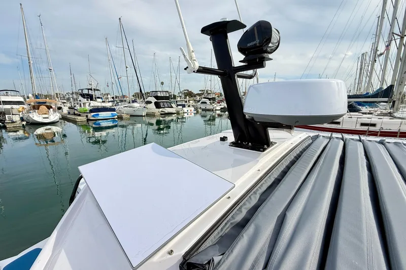 Slide: The Image of 2025 Axopar 37 XC Cross Cabin at marina, showcasing radar and equipment. - 56