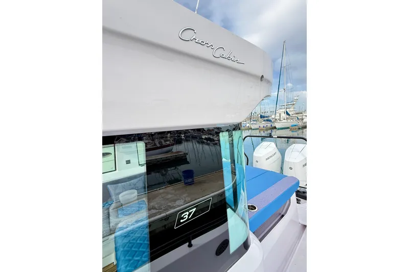 Slide: The Image of 2025 Axopar 37 XC Cross Cabin boat docked, showcasing sleek design and modern features. - 59