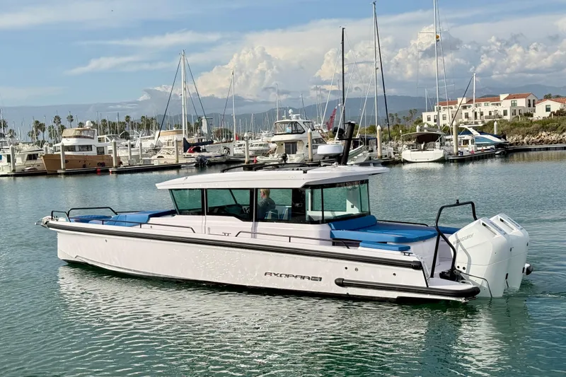 Slide: The Image of 2025 Axopar 37 XC Cross Cabin boat with Mercury engines on water. - 8