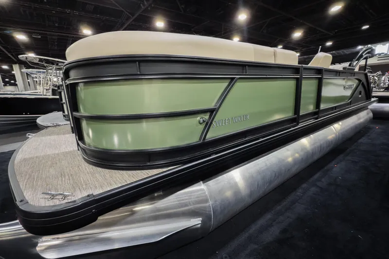 The Image of 2026 Godfrey Sweetwater 22' Tritoon boat with green exterior and single flip lounge. - 0