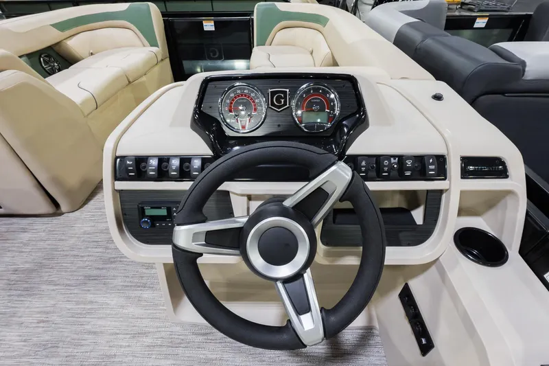Slide: The Image of 2026 Godfrey Sweetwater 22' Tritoon dashboard with modern steering and controls. - 11