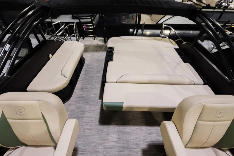 Slide: The Image of 2026 Godfrey Sweetwater 22' Tritoon interior with luxurious seating and flip lounge. - 14