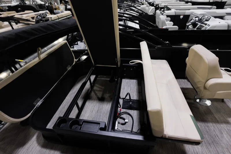 Slide: The Image of 2026 Godfrey Sweetwater 22' Tritoon interior with flip lounge and storage compartment. - 15