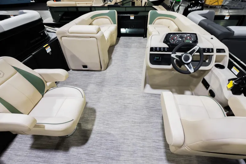 Slide: The Image of Luxurious interior of 2026 Godfrey Sweetwater 22' Tritoon with plush seating and modern dashboard. - 17