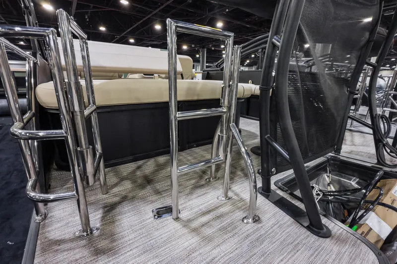 Slide: The Image of 2026 Godfrey Sweetwater 22' Tritoon interior with chrome railings and seating. - 19