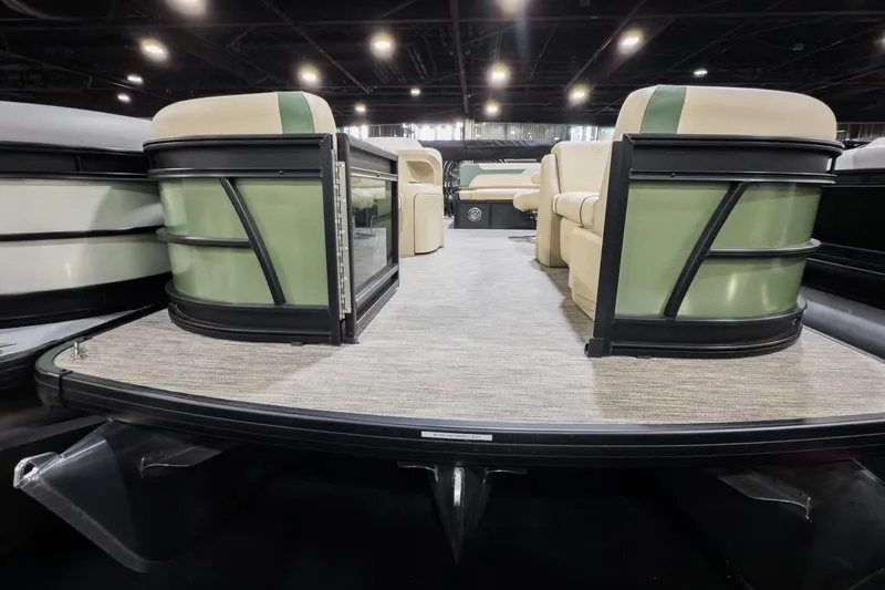 Slide: The Image of 2026 Godfrey Sweetwater 22' Tritoon with flip lounge seating, showcased indoors. - 4