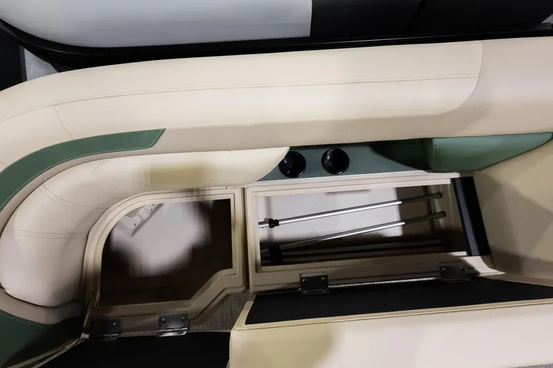 Slide: The Image of Interior storage of 2026 Godfrey Sweetwater 22' Tritoon, featuring beige and green seating. - 6