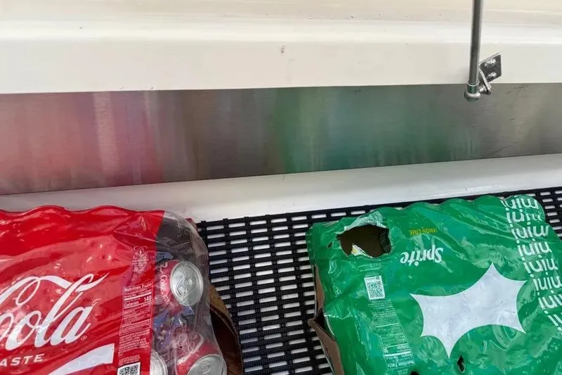 Slide: The Image of Packages of Coca-Cola and Sprite on a Boston Whaler 380 Outrage, 2024 model. - 11