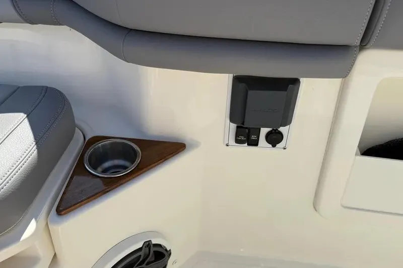 Slide: The Image of 2024 Boston Whaler 380 Outrage interior with cup holder and control panel. - 20