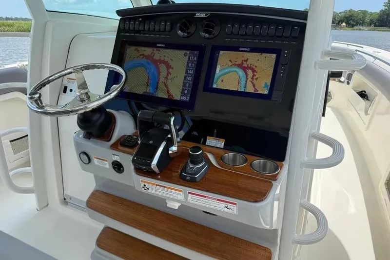 Slide: The Image of 2024 Boston Whaler 380 Outrage helm with dual navigation screens and modern controls. - 23
