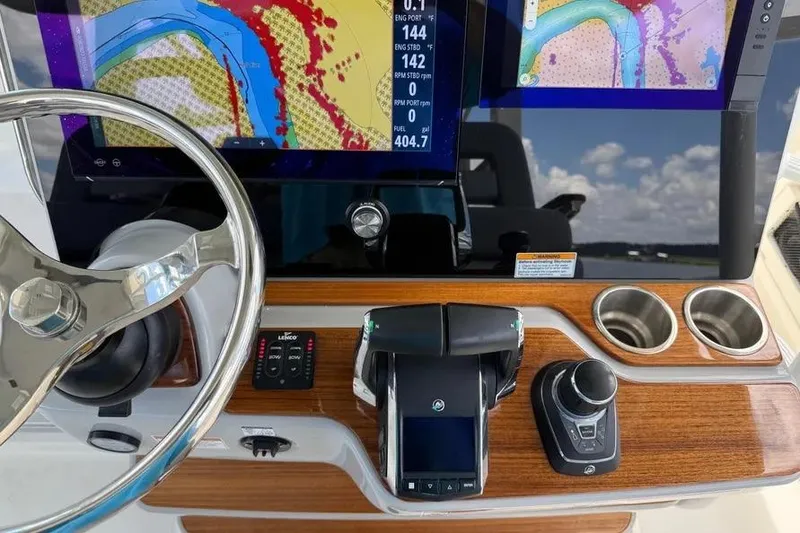 Slide: The Image of 2024 Boston Whaler 380 Outrage helm with advanced navigation displays and controls. - 24