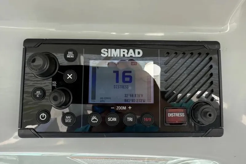 Slide: The Image of Simrad marine radio on 2024 Boston Whaler 380 Outrage, displaying distress channel 16. - 25