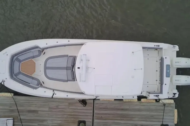 Slide: The Image of Aerial view of 2024 Boston Whaler 380 Outrage docked, showcasing sleek design and spacious layout. - 4