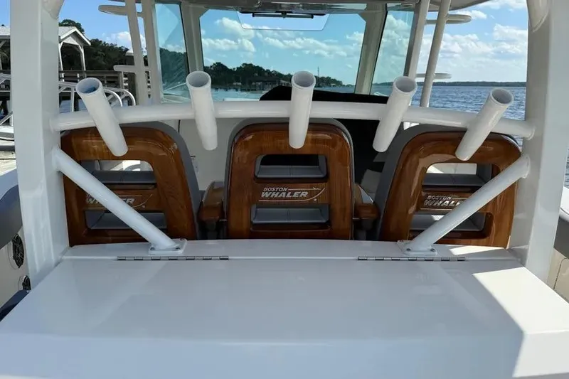 Slide: The Image of 2024 Boston Whaler 380 Outrage boat interior with rod holders and seating. - 7