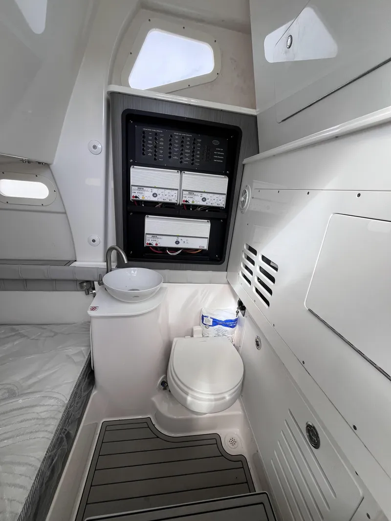 Slide: The Image of Interior of 2021 Sea Fox 368 Commander boat, featuring a compact bathroom with toilet and sink. - 26