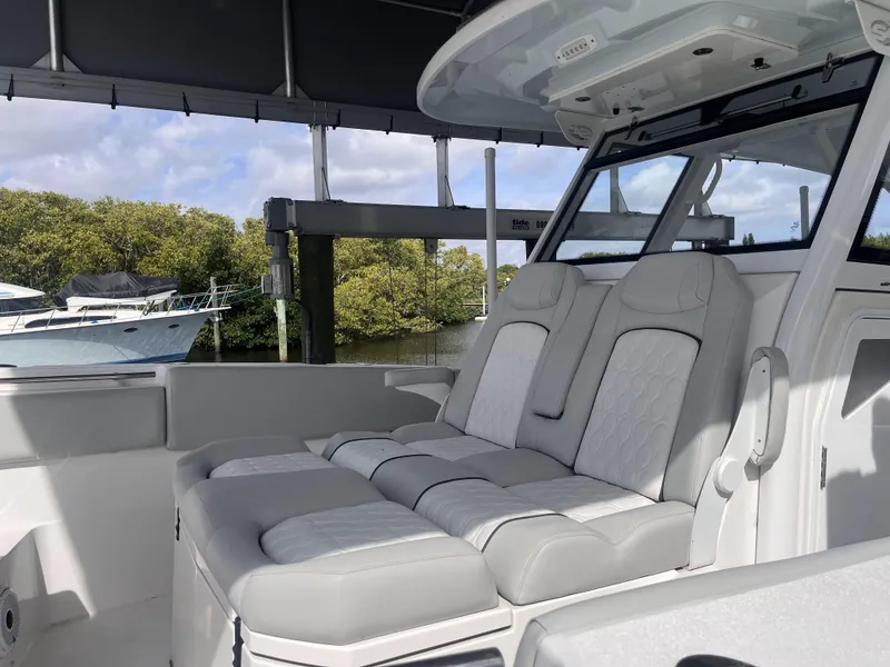 Slide: The Image of 2021 Sea Fox 368 Commander boat interior with cushioned seating under canopy. - 30