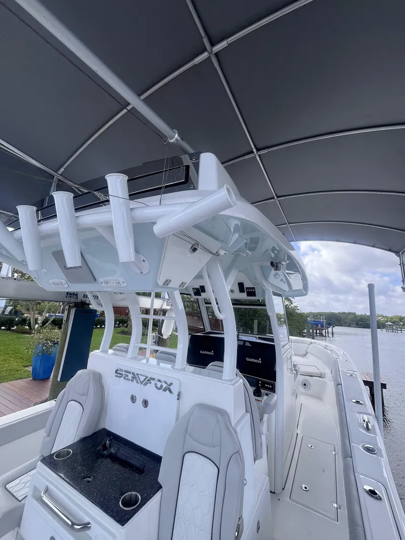 Slide: The Image of 2021 Sea Fox 368 Commander boat interior with rod holders and helm station. - 9