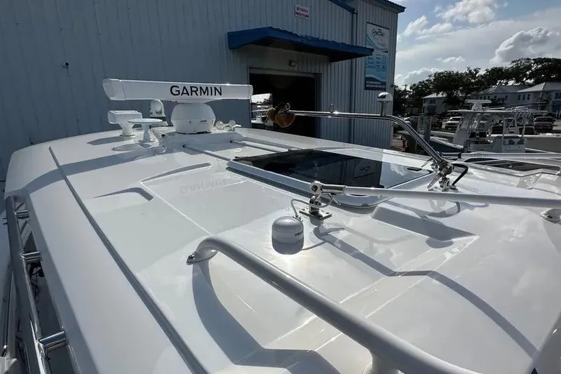 Slide: The Image of 2024 Pursuit S 358 Sport boat with Garmin radar, docked near a blue building. - 10