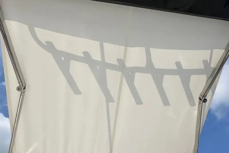 Slide: The Image of Shadow of boat canopy on Pursuit S 358 Sport, 2024 model, against blue sky. - 12