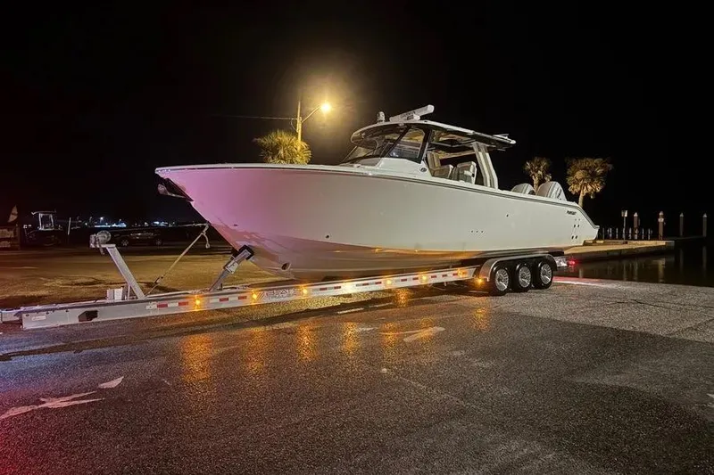 Slide: The Image of 2024 Pursuit S 358 Sport boat on trailer at night, illuminated by streetlight. - 17