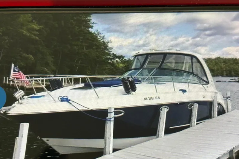 The Image of 2009 Chaparral Signature 350 boat docked by a scenic lakeside with trees. - 1
