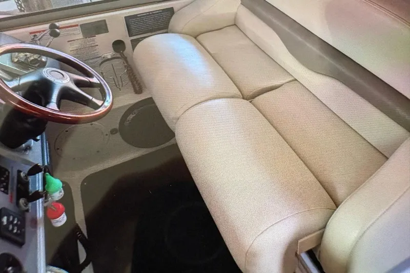 Slide: The Image of 2009 Chaparral Signature 350 boat interior with beige seating and wooden steering wheel. - 13