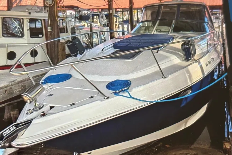 Slide: The Image of 2009 Chaparral Signature 350 boat docked in a marina, showcasing sleek design. - 17