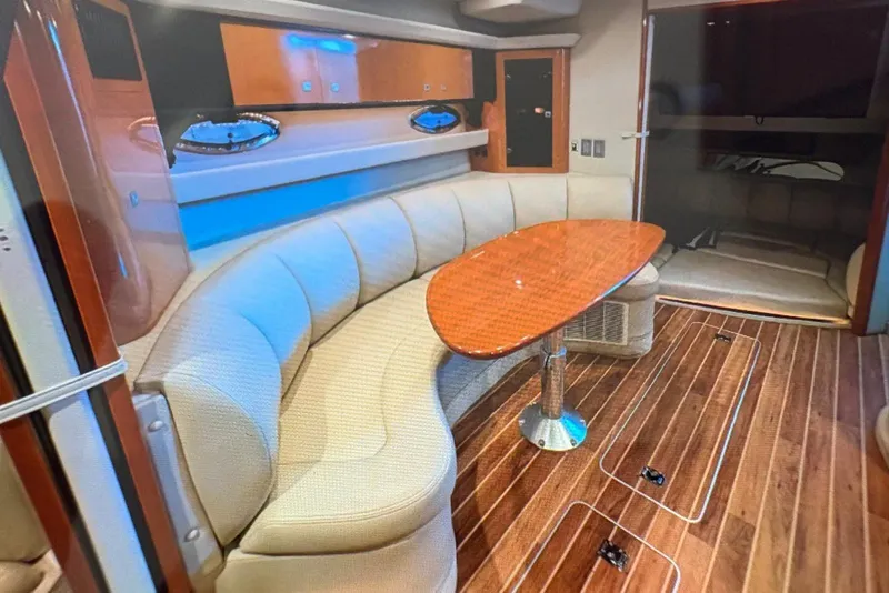 Slide: The Image of 2009 Chaparral Signature 350 interior with curved seating and wooden table. - 18