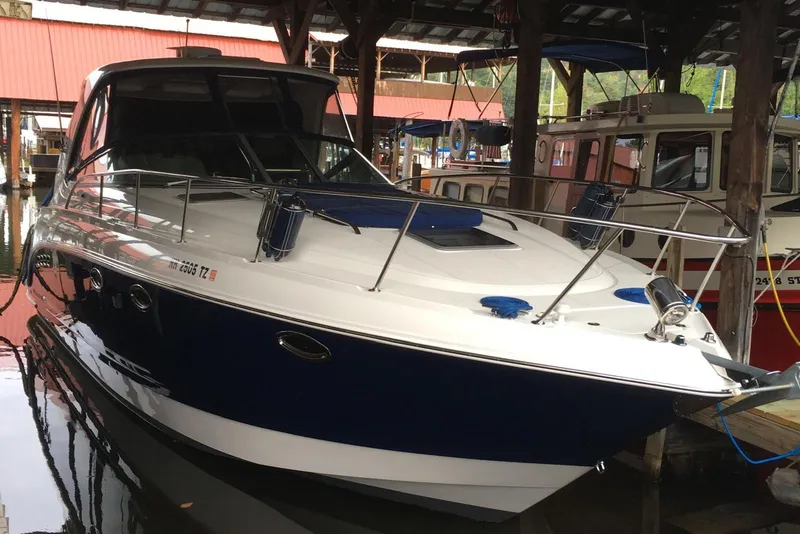 Slide: The Image of 2009 Chaparral Signature 350 boat docked in a marina under a covered shelter. - 2