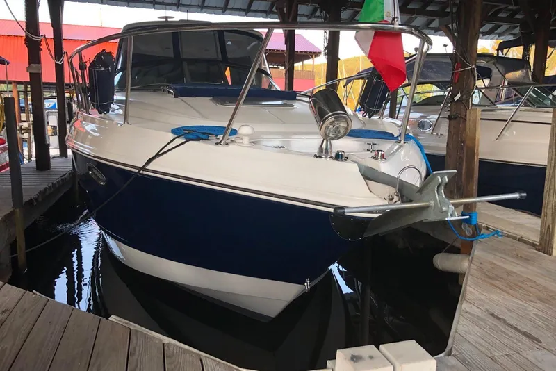 Slide: The Image of 2009 Chaparral Signature 350 boat docked, featuring a sleek blue and white design. - 3