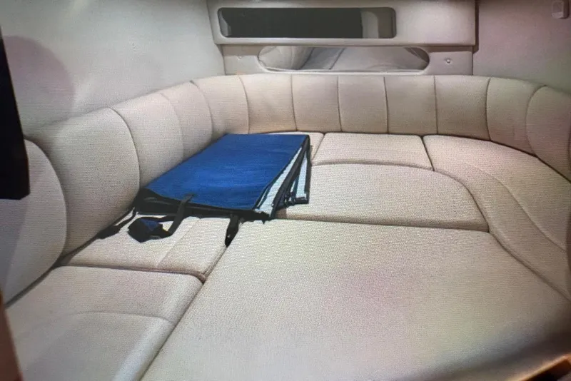 Slide: The Image of 2009 Chaparral Signature 350 cabin interior with beige seating and blue cushion. - 6