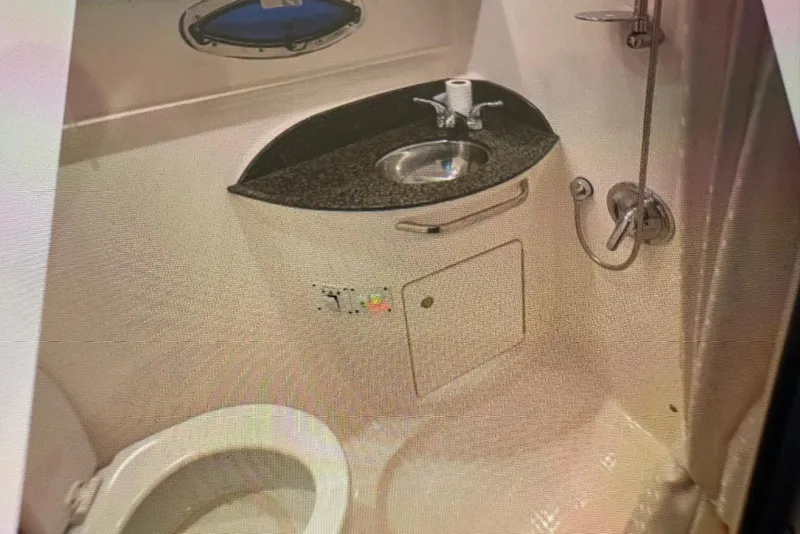 Slide: The Image of 2009 Chaparral Signature 350 bathroom with sink, toilet, and shower. - 7