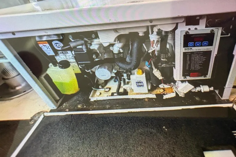 Slide: The Image of Engine compartment of a 2009 Chaparral Signature 350 boat, showing various mechanical components. - 8