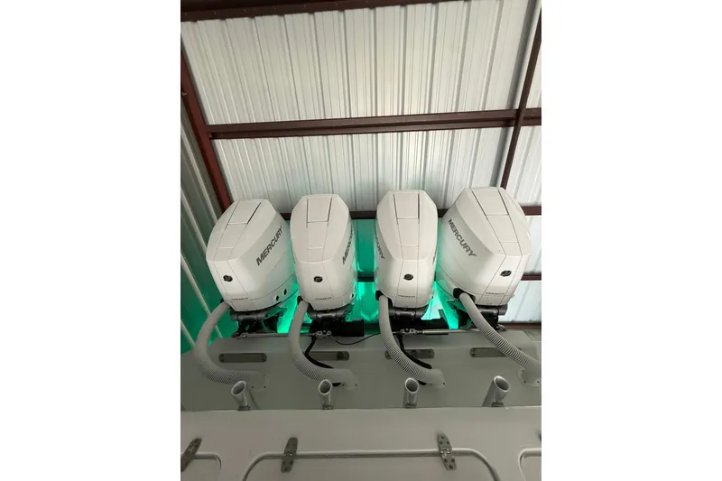 Slide: The Image of Four Mercury outboard engines on a 2025 Contender 44 ST boat. - 13