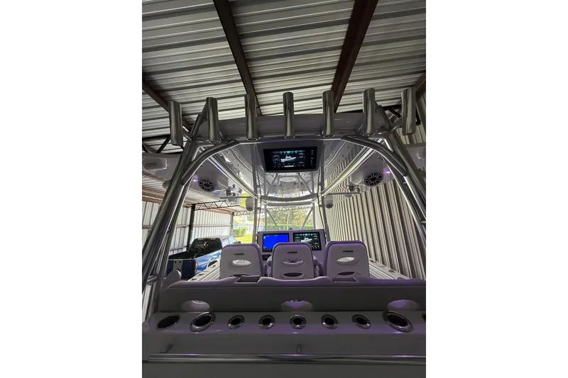Slide: The Image of 2025 Contender 44 ST boat interior with advanced navigation displays and seating. - 15