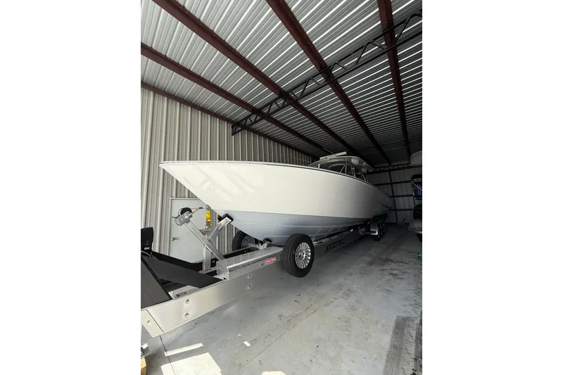 Slide: The Image of 2025 Contender 44 ST boat on trailer in storage facility. - 18