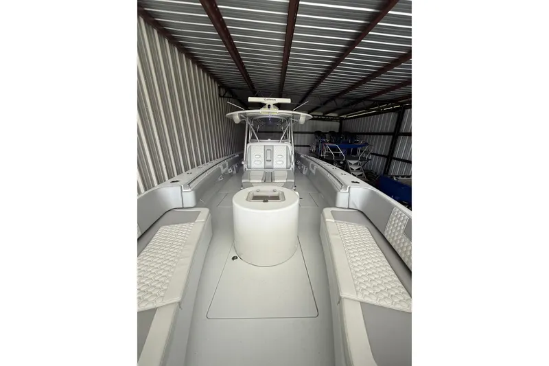 Slide: The Image of 2025 Contender 44 ST boat interior in storage, featuring seating and helm. - 4