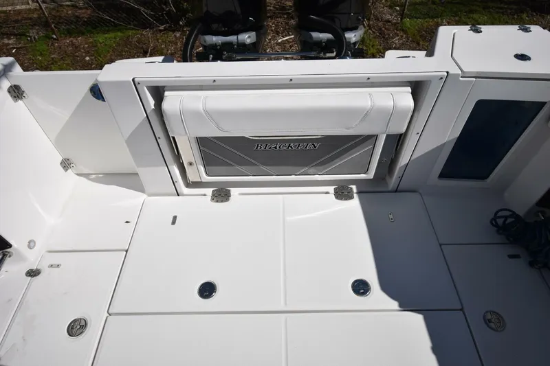Slide: The Image of 2021 Blackfin 332 CC boat deck with storage compartment and seating. - 11
